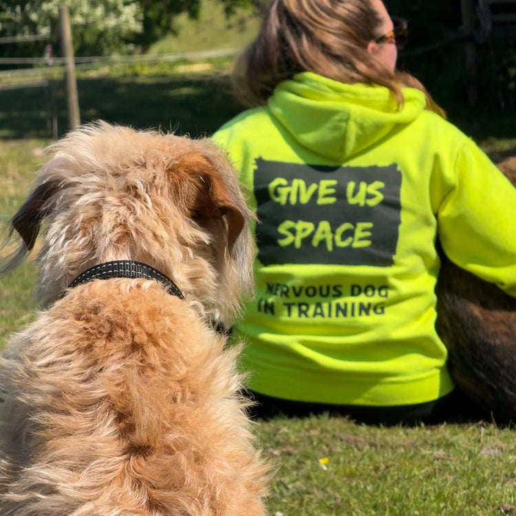tattooed-man-in-the-outdoors-wearing-yellow-nervy-mutt-give-us-space-nervous-dog-training-hoody