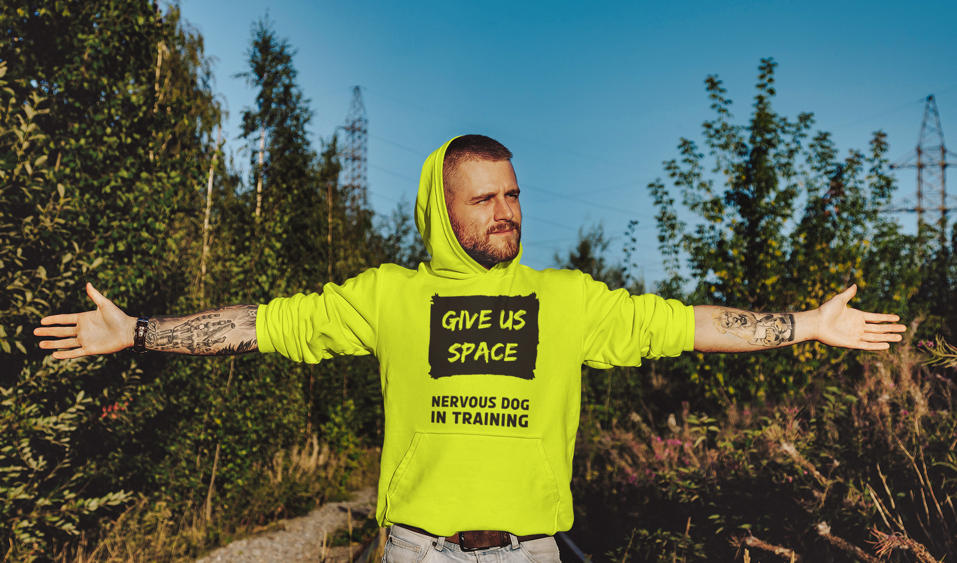 tattooed-man-in-the-outdoors-wearing-yellow-nervy-mutt-give-us-space-nervous-dog-training-hoody